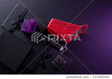 Festive background composition of elegant black gift boxes with black satin ribbons and bows, symbolizing the Black Friday sale. 133448260