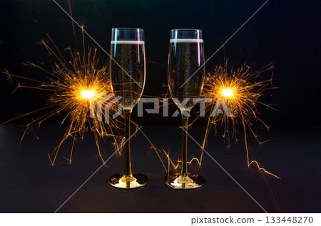 Happy New Year 2026, New Year's Eve holiday greeting card celebration. Sparklers firework, champagne glasses on black background Happy New Year 2026, New Year's Eve holiday greeting card celebration. Sparklers firework, champagne glasses on black background 133448270