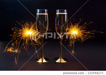 Happy New Year 2026, New Year's Eve holiday greeting card celebration. Sparklers firework, champagne glasses on black background Happy New Year 2026, New Year's Eve holiday greeting card celebration. Sparklers firework, champagne glasses on black background 133448271