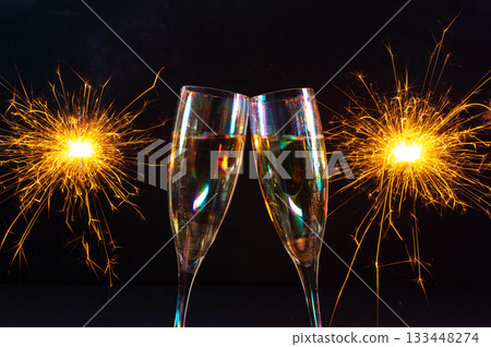 Happy New Year 2026, New Year's Eve holiday greeting card celebration. Sparklers firework, champagne glasses on black background Happy New Year 2026, New Year's Eve holiday greeting card celebration. Sparklers firework, champagne glasses on black background 133448274