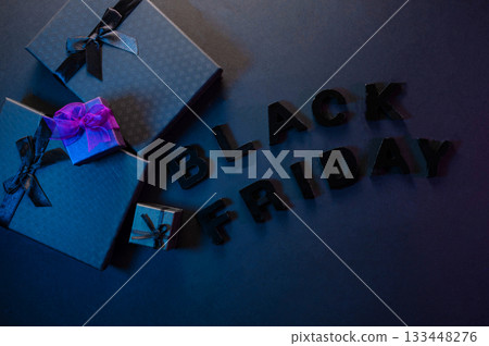 Festive background composition of elegant black gift boxes with black satin ribbons and bows, symbolizing the Black Friday sale. 133448276