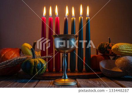 Kwanzaa, african holiday Kwanzaa with decoration of seven candles in red, black and green colors, vegetable harvest, corn. Greeting card banner. Happy Kwanzaa Kwanzaa, african holiday Kwanzaa with decoration of seven candles in red, black and green colors, vegetable harvest, corn. Greeting card banner. Happy Kwanzaa 133448287