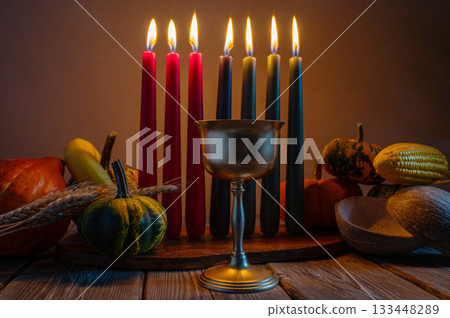Kwanzaa, african holiday Kwanzaa with decoration of seven candles in red, black and green colors, vegetable harvest, corn. Greeting card banner. Happy Kwanzaa Kwanzaa, african holiday Kwanzaa with decoration of seven candles in red, black and green colors, vegetable harvest, corn. Greeting card banner. Happy Kwanzaa 133448289