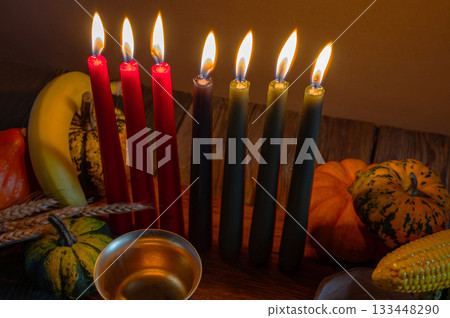 Kwanzaa, african holiday Kwanzaa with decoration of seven candles in red, black and green colors, vegetable harvest, corn. Greeting card banner. Happy Kwanzaa Kwanzaa, african holiday Kwanzaa with decoration of seven candles in red, black and green colors, vegetable harvest, corn. Greeting card banner. Happy Kwanzaa 133448290