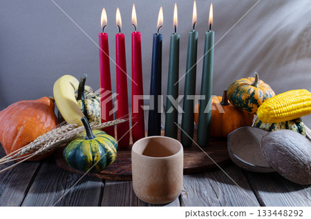 Kwanzaa, african holiday Kwanzaa with decoration of seven candles in red, black and green colors, vegetable harvest, corn. Greeting card banner. Happy Kwanzaa Kwanzaa, african holiday Kwanzaa with decoration of seven candles in red, black and green colors, vegetable harvest, corn. Greeting card banner. Happy Kwanzaa 133448292