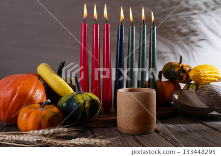 Kwanzaa, african holiday Kwanzaa with decoration of seven candles in red, black and green colors, vegetable harvest, corn. Greeting card banner. Happy Kwanzaa Kwanzaa, african holiday Kwanzaa with decoration of seven candles in red, black and green colors, vegetable harvest, corn. Greeting card banner. Happy Kwanzaa 133448295