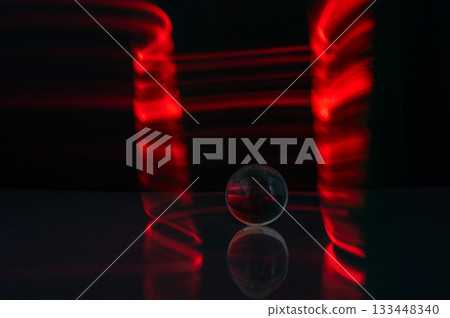 Abstract colorful irregular lines with glass bubble on black background and wall texture. Long exposure. Light painting photography. 133448340