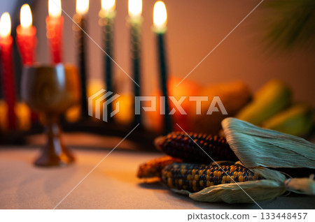Happy Kwanzaa. Seven candles red, black and green on a natural wooden background. Harvest and gifts. Symbols of African heritage. Happy Kwanzaa. Seven candles red, black and green on a natural wooden background. Harvest and gifts. Symbols of African heritage. 133448457