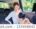 Mother with child fastening seat belt in taxi 133448642