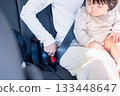 Mother with child fastening seat belt in taxi 133448647