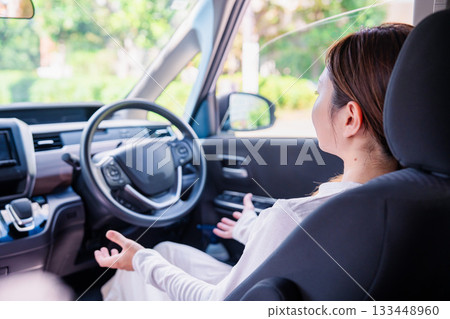 A young woman driving a self-driving car A young woman driving a self-driving car 133448960