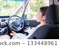 A young woman driving a self-driving car 133448961