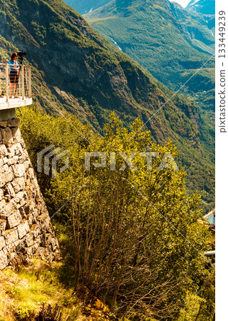 Tourist with camera on tripod in Norway nature Tourist with camera on tripod in Norway nature 133449239