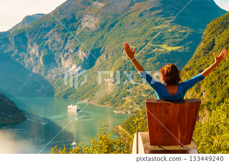 Tourist enjoy Geiranger fjord from viewpoint seat Tourist enjoy Geiranger fjord from viewpoint seat 133449240