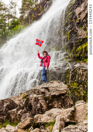 Tourist woman at waterfall Svandalsfossen, Norway 133449243