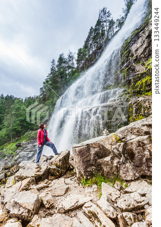 Tourist woman at waterfall Svandalsfossen, Norway Tourist woman at waterfall Svandalsfossen, Norway 133449244