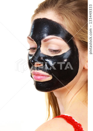 Girl black carbo peel off mask on face 133449333