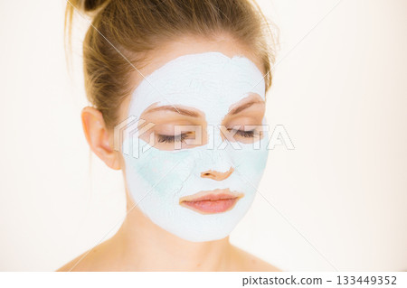Girl with green mud mask on face Girl with green mud mask on face 133449352