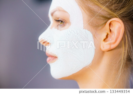 Girl with green mud mask on face Girl with green mud mask on face 133449354
