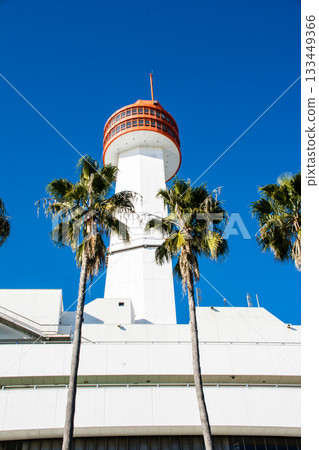 The Ship Science Museum building with its white walls and orange observation deck under the bright blue sky and dazzling sunlight 133449366