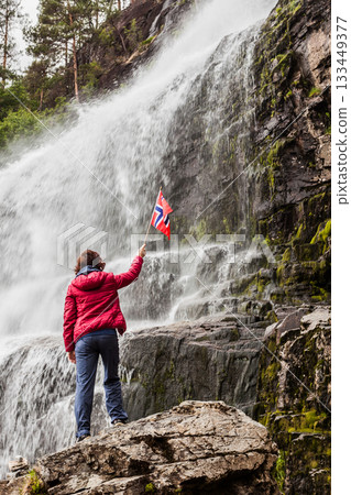 Tourist woman at waterfall Svandalsfossen, Norway 133449377