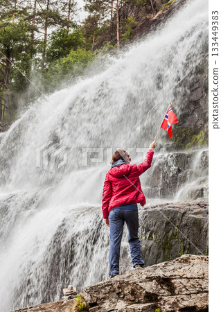 Tourist woman at waterfall Svandalsfossen, Norway 133449383