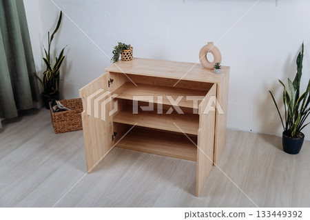 Wooden storage cabinet with open doors and adjustable shelves in modern interior Wooden storage cabinet with open doors and adjustable shelves in modern interior 133449392