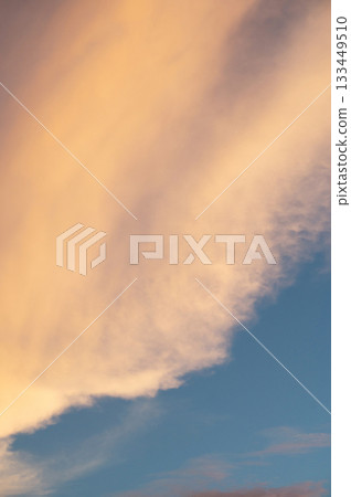 Beautiful sunset clouds blend orange and blue over the horizon 133449510