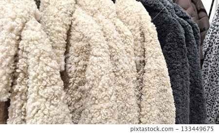 Warm fleece and wool coats in assorted colors on display 133449675