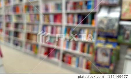 Blurred bookshelves in library with colorful books Blurred bookshelves in library with colorful books 133449677