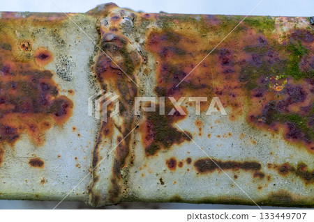 Close-up of rust and moss on weathered metal surface 133449707