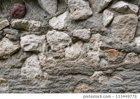 Rustic stone wall with various rock shapes and textures Rustic stone wall with various rock shapes and textures 133449778