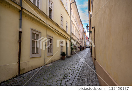 Prague, Czech Republic, August 9, 2023. A charming cobblestone alley in the Old Town. Perspective view. Travel destinations. Prague, Czech Republic, August 9, 2023. A charming cobblestone alley in the Old Town. Perspective view. Travel destinations. 133450187