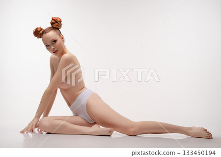 Beauty woman in a studio posing topless with stylish hair and elegance Beauty woman in a studio posing topless with stylish hair and elegance 133450194