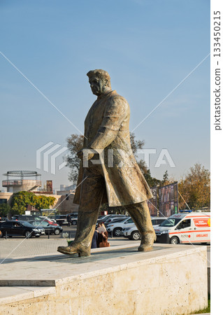 A statue of a man walking on a sidewalk A statue of a man walking on a sidewalk 133450215