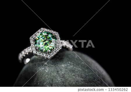 A green diamond ring sits on a rock A green diamond ring sits on a rock 133450262