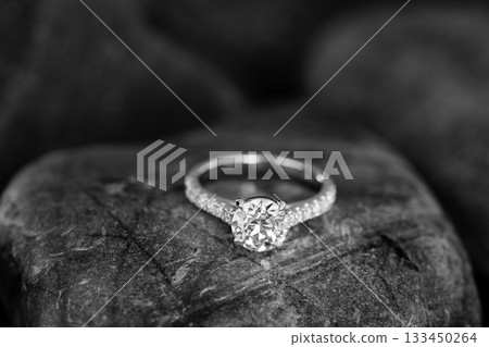 A diamond ring is on a rock A diamond ring is on a rock 133450264