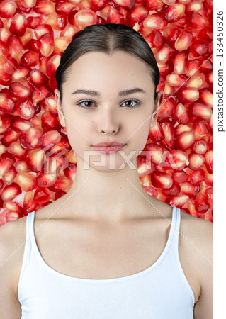 Young beautiful woman in red pomegranate seeds background Young beautiful woman in red pomegranate seeds background 133450326