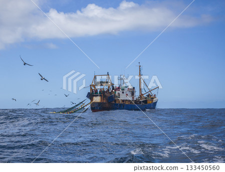 Oceanic trawler lifts trawl in the waters of the Southern Ocean. 133450560