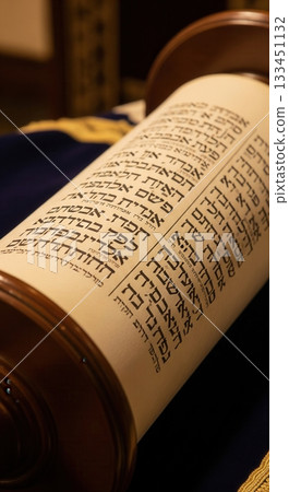 A detailed close-up of an open Torah scroll showing the ancient Hebrew script. The image evokes a sense of sacredness and tradition. Ideal for materials about Judaism or spirituality. 133451132