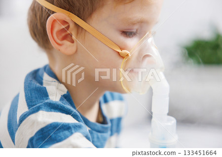 Child Using Nebulizer for Respiratory Treatment at Home 133451664