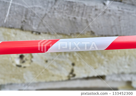 Fenced red tape.Construction debris.Old insulation material removed from walls Fenced red tape.Construction debris.Old insulation material removed from walls 133452300