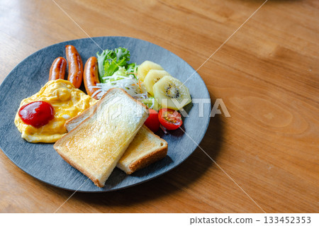 Western-style breakfast plate with toast, scrambled eggs and sausage Western-style breakfast plate with toast, scrambled eggs and sausage 133452353