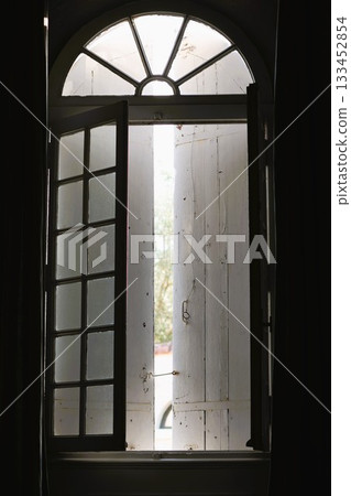 Old vertical window and sun light 133452854