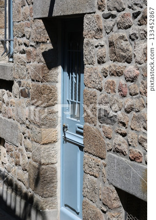 Old blue door in rocky castle. 133452867