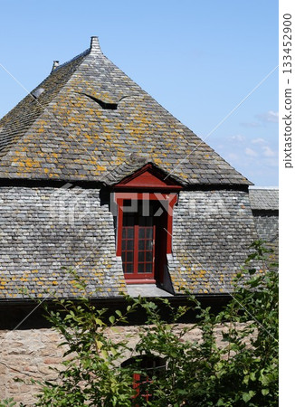 Old building with red windows and doors. 133452900