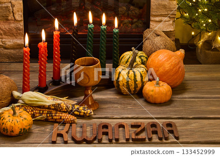 Kwanzaa Celebration. Festive Kwanzaa setup with candles, corn, and pumpkins 133452999