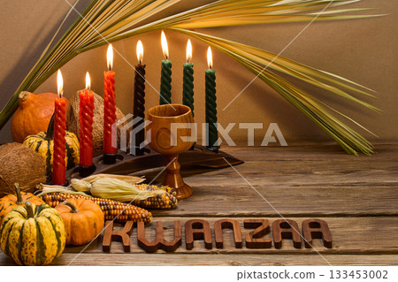 Kwanzaa Celebration Setup. A festive Kwanzaa display with candles, fruits, and decorative elements Kwanzaa Celebration Setup. A festive Kwanzaa display with candles, fruits, and decorative elements 133453002
