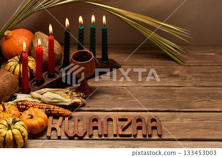 Kwanzaa Celebration Setup. A festive Kwanzaa display with candles, fruits, and decorative elements Kwanzaa Celebration Setup. A festive Kwanzaa display with candles, fruits, and decorative elements 133453003