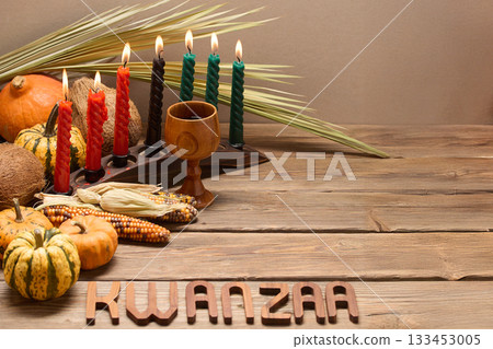 Kwanzaa Celebration Setup. A festive Kwanzaa display with candles, fruits, and decorative elements Kwanzaa Celebration Setup. A festive Kwanzaa display with candles, fruits, and decorative elements 133453005